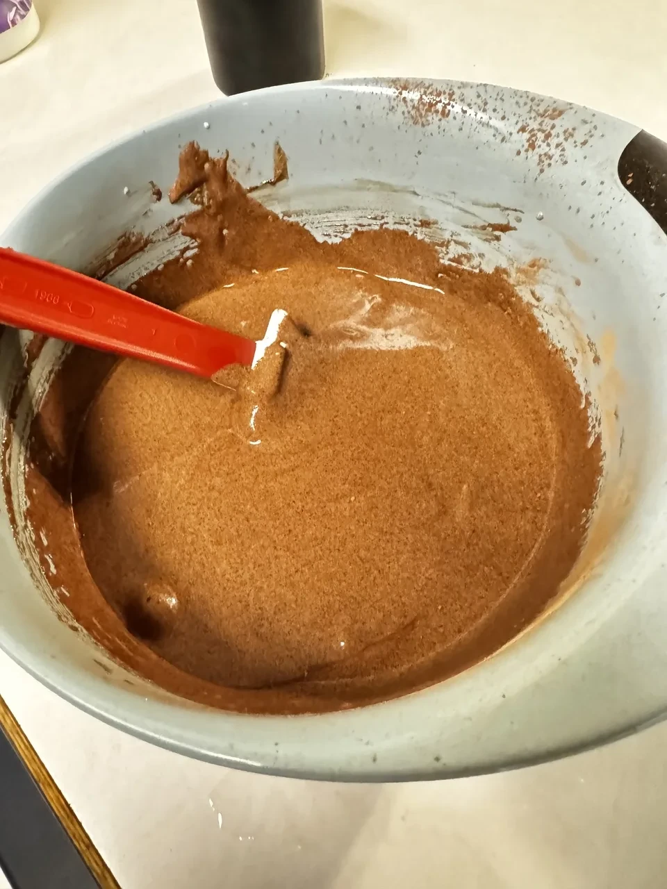 a mixing bowl containing slightly lighter brown batter