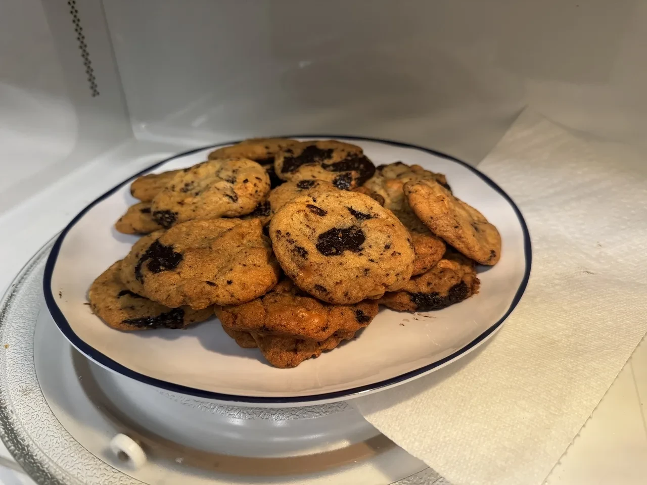 twelve cookies sitting on a plate in a microwave