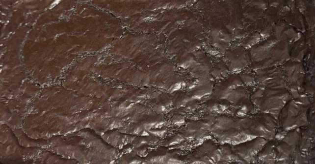 a close-up view of the crinkly surface of freshly-baked brownies